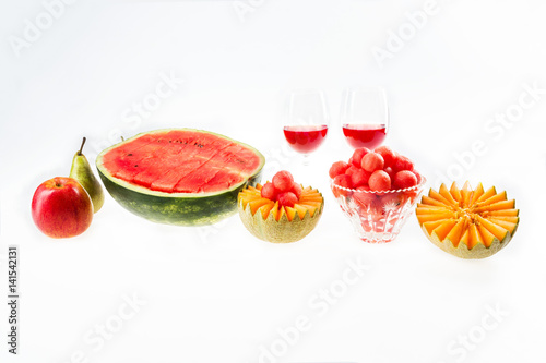 Dietary food  detox. Red watermelon and yellow melon  apple  pear and glasses with juice isolated on white background.