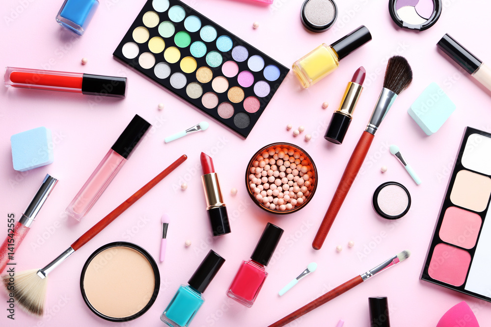 Different makeup cosmetics on a pink background Different makeup cosmetics on a pink background