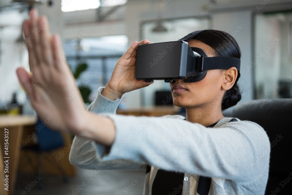 Businesswoman using virtual reality headset Businesswoman using virtual reality headset