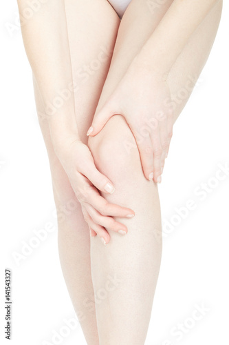 Woman touching her fatigued legs isolated on white  clipping path