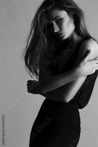 fashion portrait of elegant woman with perfect provocative make up. Studio shot. monochrome photo