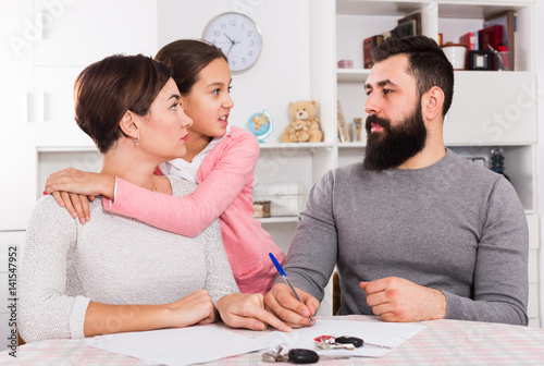 Parents signing divorce papers photo