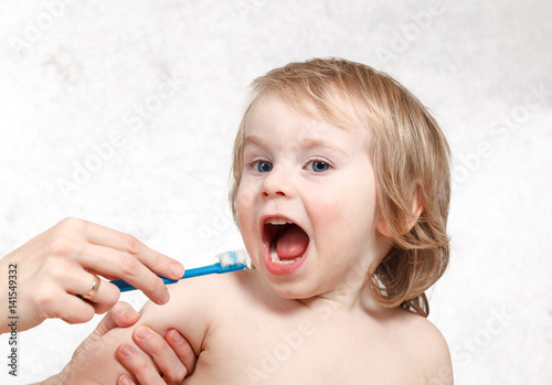 Mom brush cleans teeth funny blond kid 2 years