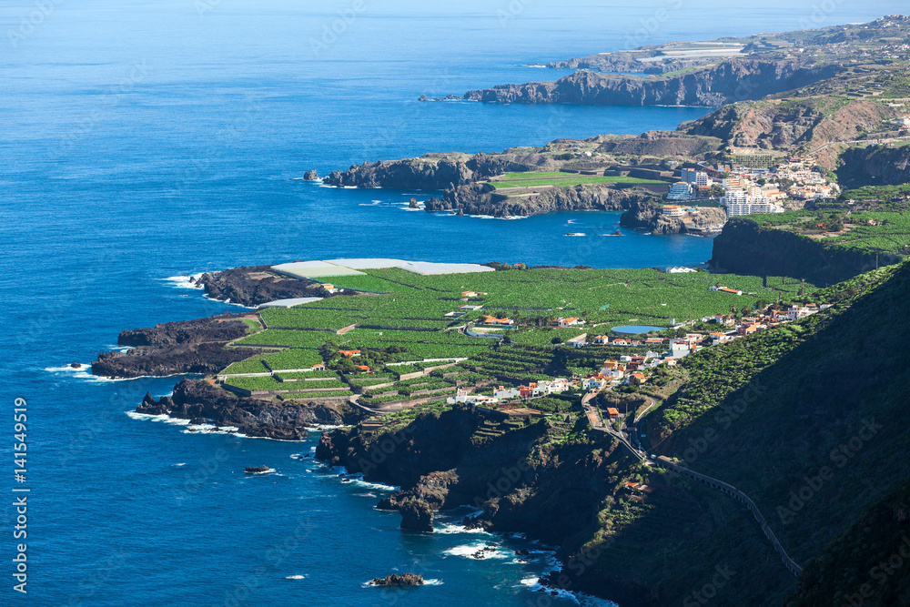 Shoreline of northern side of Tenerife island with blue Atlantic ocean. Aerial view at green plantations. The Canary, Spain, Europe