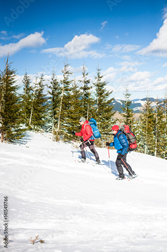 Two climbers are in the mountains.