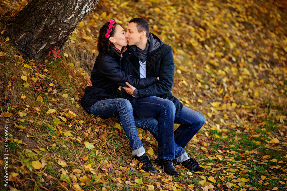 Parents look at children in autumn park Parents look at children in autumn park