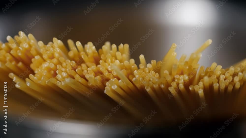 Pasta spaghetti tied up by a rope isolated on a black background Pasta spaghetti tied up by a rope isolated on a black background