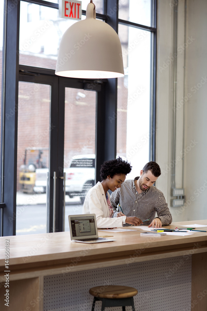 Young woman and man sitting at bar counter Young woman and man sitting at bar counter