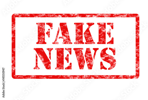 rubber stamp print in red with words fake news on white background