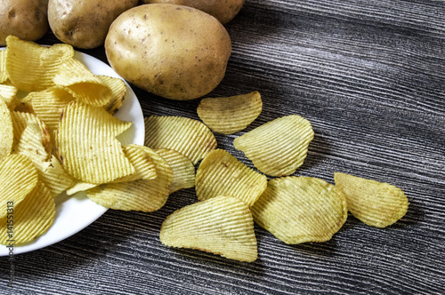 potatoes and potato products, fried potato slices, potato slices fried serrated, fried potato flakes in a furnace,
