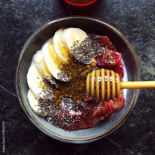 Bowl of fruits with honey and seeds