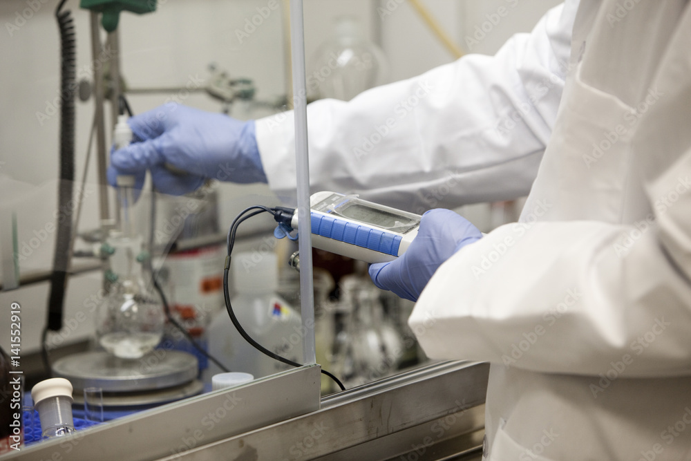 Scientist using pipette in laboratory Scientist using pipette in laboratory