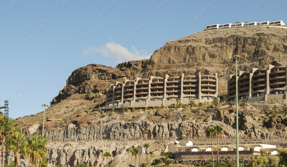 City view with white buildings in the mountains. Playa de Amadores, Gran Canaria, Spain.