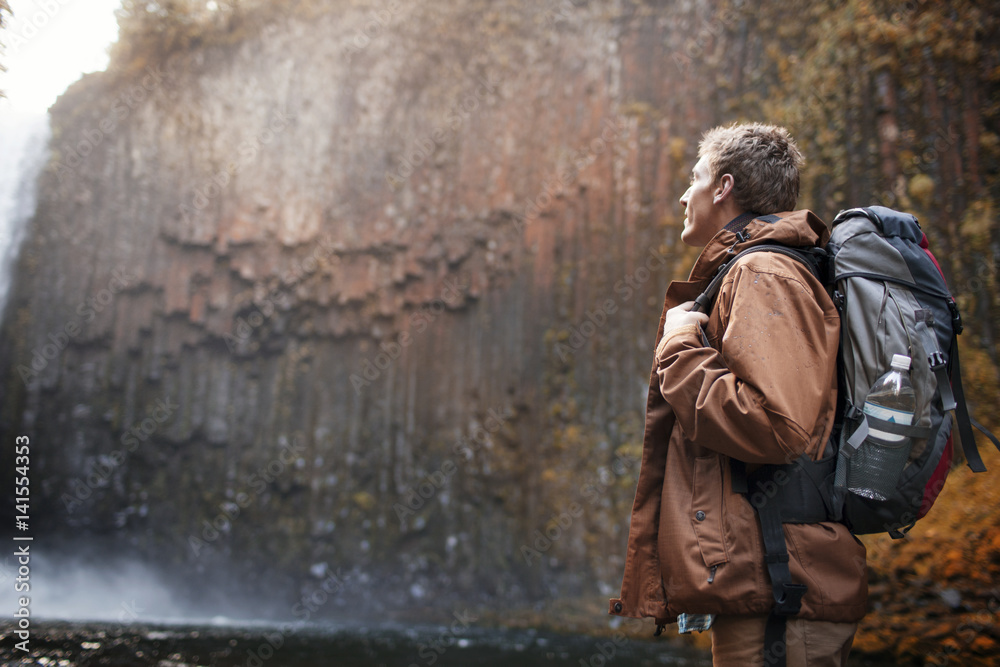 Hiker with backpack looking at view Hiker with backpack looking at view