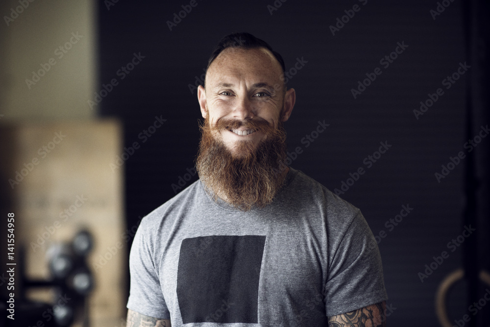 Portrait of smiling man with beard in gym Portrait of smiling man with beard in gym