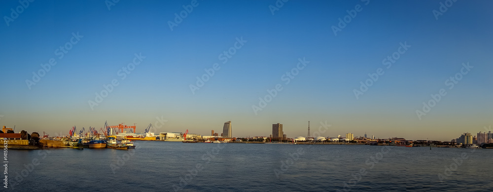 SHANGHAI, CHINA: Shanghai riverbank, industrial boats and some port facilities lying waterfront, beautiful blue sky