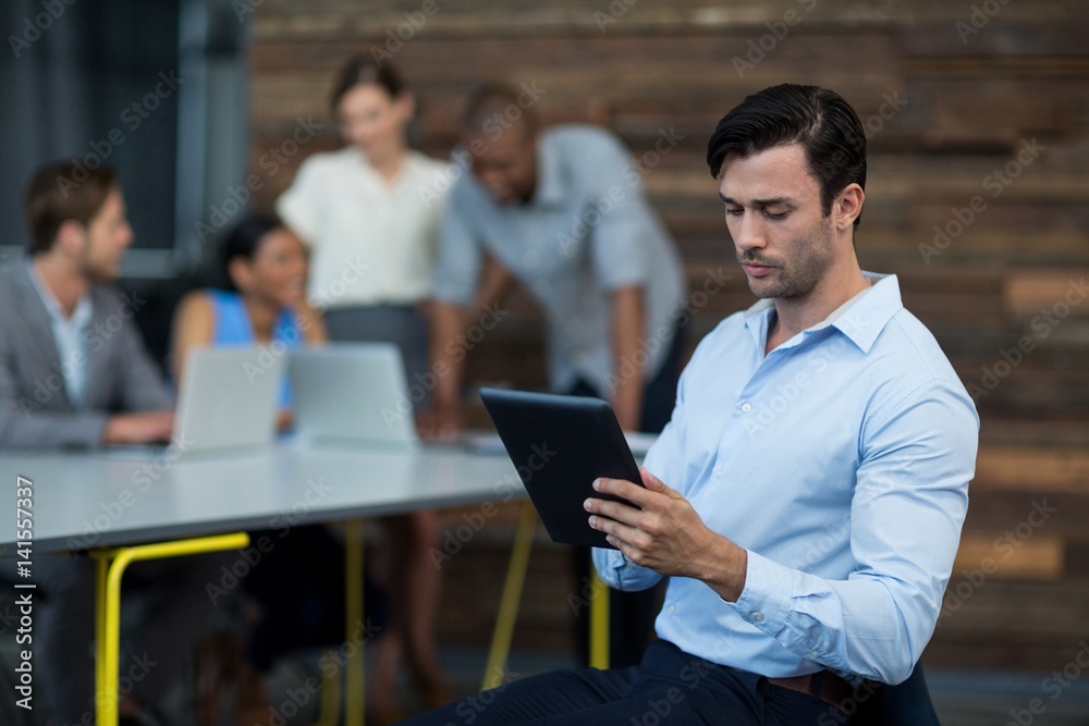 Business executive using digital tablet in office Business executive using digital tablet in office