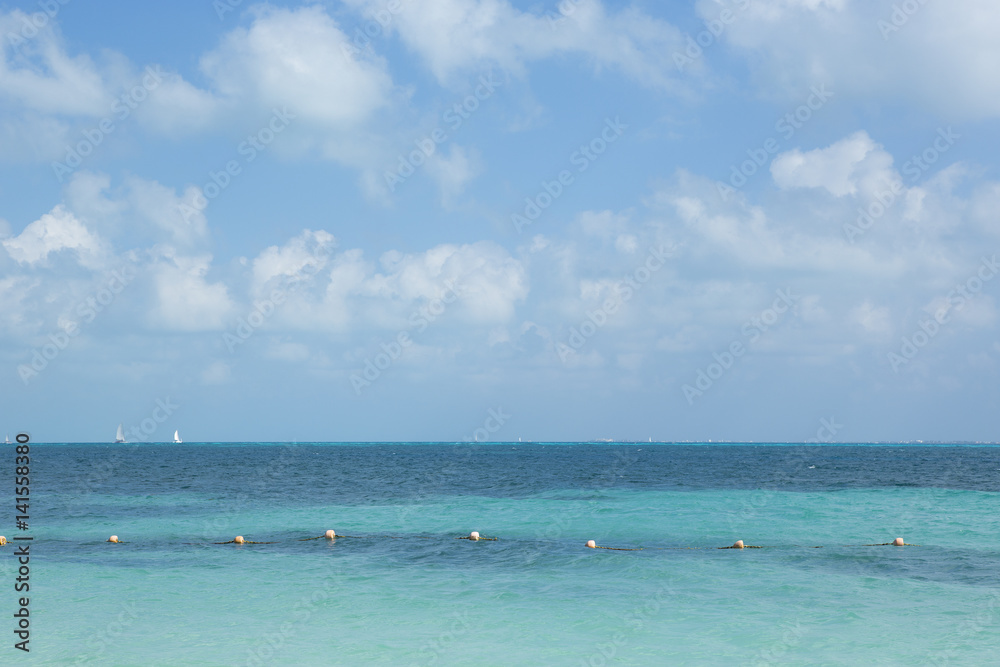 Turquoise water. An image of the Caribbean ocean. Sail boats on the background. Horizon. Turquoise water. An image of the Caribbean ocean. Sail boats on the background. Horizon.