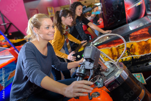 Woman on arcade motorcycle