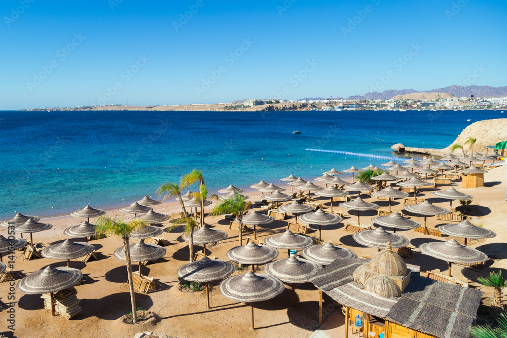 The big deserted beach. Closed beach and sun loungers. Egypt The big deserted beach. Closed beach and sun loungers. Egypt
