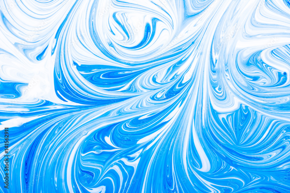 Blue and white paint mixing making swirls background. Blue and white paint mixing making swirls background.