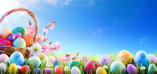 Easter Eggs In Basket And On Meadow
