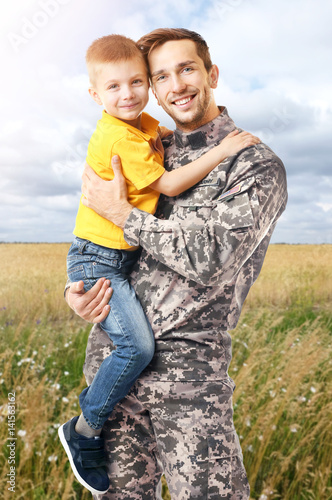 Military father with his so...