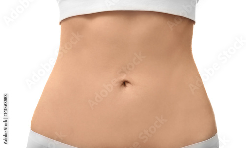 Female tummy on white background. Plastic surgery concept © Africa Studio
