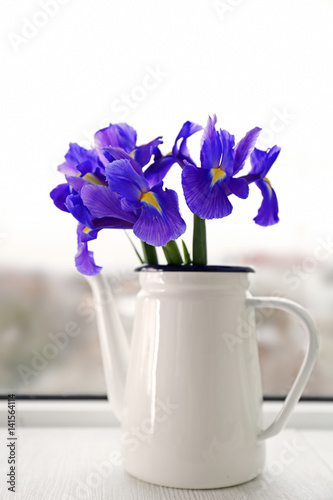 Vase with bouquet of beautiful flowers on light background