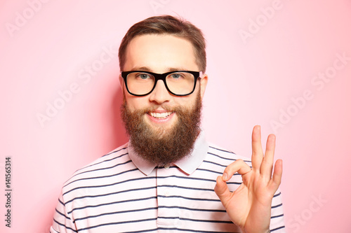 Handsome young man on pink ...