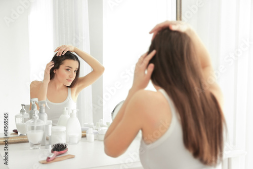 Young woman with hair loss ...
