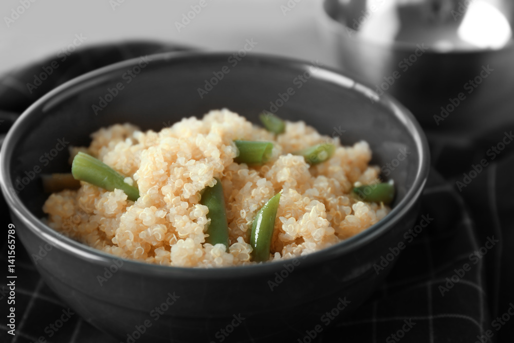 Cooked quinoa with French beans in black bowl Cooked quinoa with French beans in black bowl