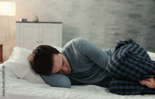 Young tired man sleeping in...