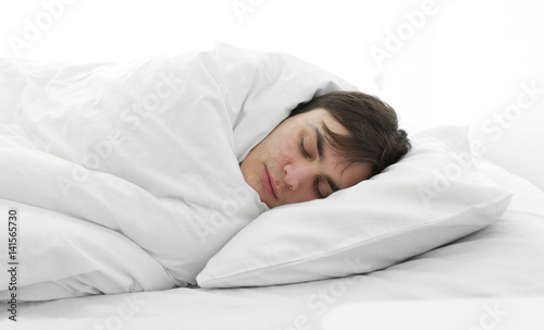 Tired young man sleeping in...