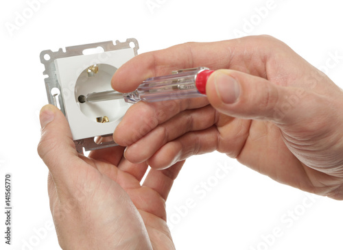 Male hands with socket and tester on white background