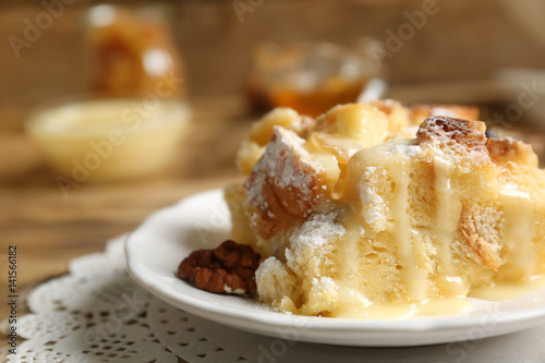 Tasty bread pudding with sugar powder on plate