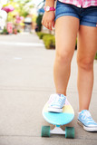 A girl's leg on the scateboard