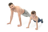 Handsome man training with his son on white background