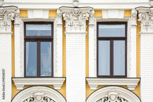 Ornate building with vintage windows and brick wall background