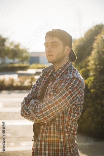 Handsome young man using his mobile phone in the steet photo