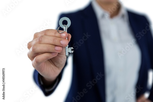 Mid section of businesswoman showing new house key