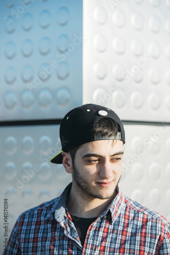 Handsome young man using his mobile phone in the steet photo