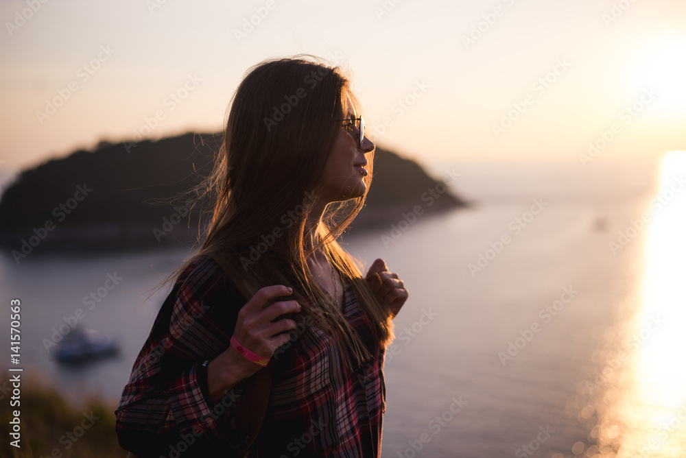 Young stylish hipster girl enjoy sunset on viewpoint. Travel woman with backpack Young stylish hipster girl enjoy sunset on viewpoint. Travel woman with backpack