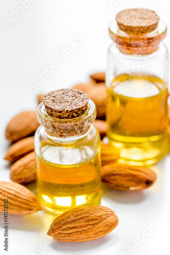 organic cosmetic with almond extract on table background