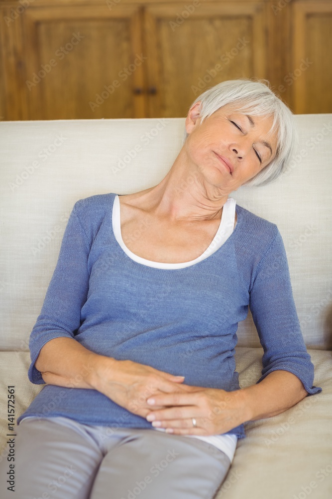 Senior woman sleeping on sofa in living room Senior woman sleeping on sofa in living room