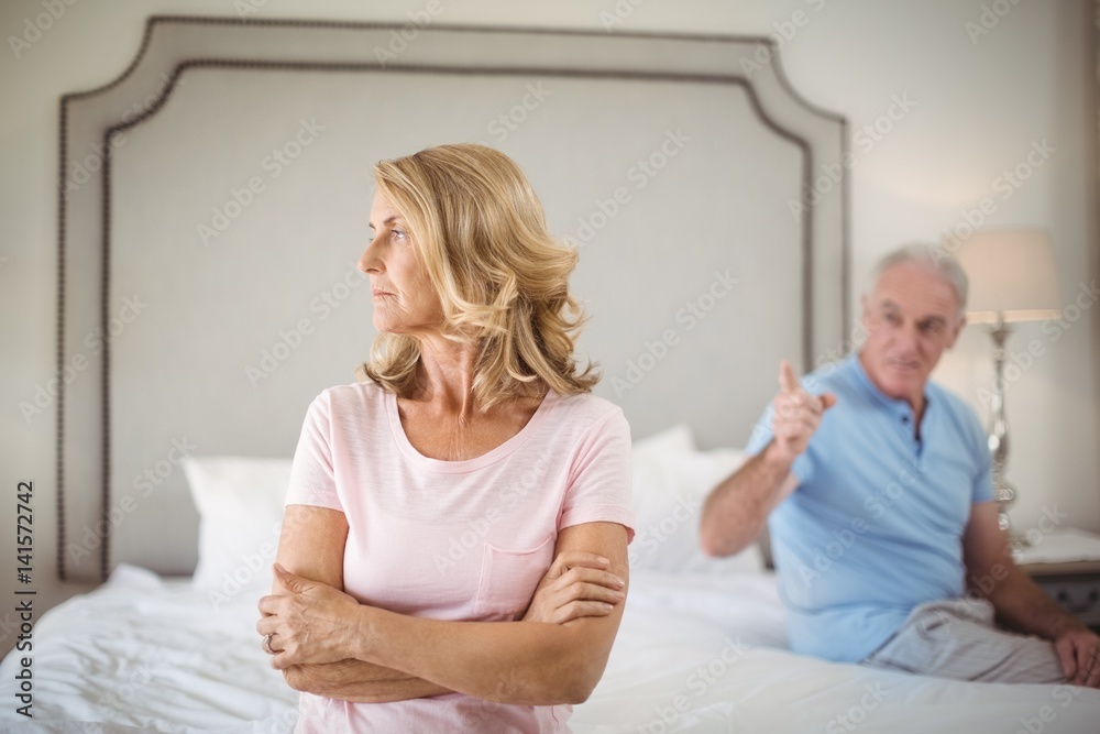 Couple having an argument in bedroom Couple having an argument in bedroom