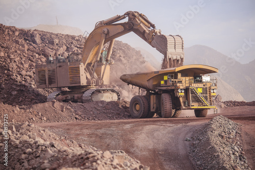 Loading of copper ore on very big dump-body truck