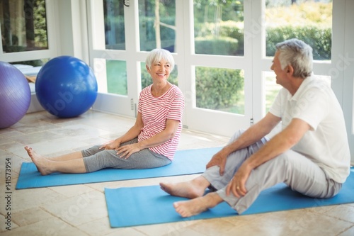 Senior couple interacting while exercising