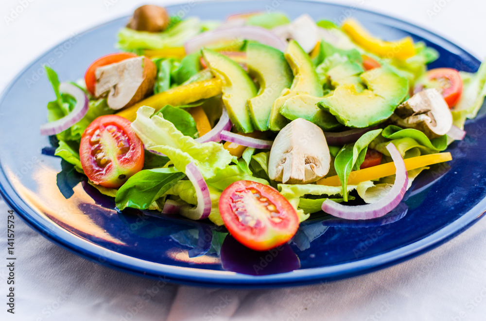 Close up photo of colorful healthy vegetarian and vegan salad with organic vegetables against white background. Selective focus. Close up photo of colorful healthy vegetarian and vegan salad with organic vegetables against white background. Selective focus.