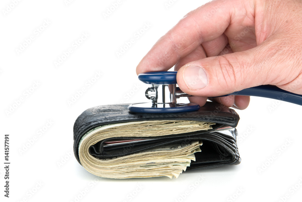 Obraz premium Wallet with cash eing examined with stethoscope.